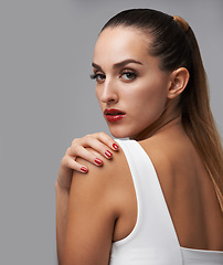 Image showing Woman, portrait and hand with makeup and manicure, nail polish and cosmetic care for skin on grey background. Face, confidence and beauty with red lipstick and color nails for glamour in studio