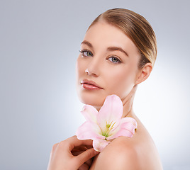 Image showing Portrait, beauty and woman with skincare, flowers and wellness on white studio background. Face, person and model with natural cosmetics and grooming with shine and glow with aesthetic or dermatology