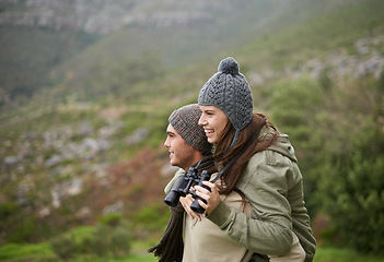 Image showing Nature hiking, binocular and happy couple on piggyback ride, having fun and enjoy mountain climbing journey. Marriage, love and people looking at adventure destination, trekking view or bird watching