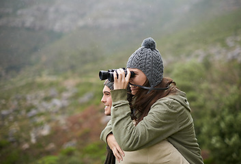 Image showing Hiking, binocular and happy couple on piggyback ride, nature exploration and mountain climbing journey. Camping tour, love and people look at eco friendly destination, trekking view or bird watching