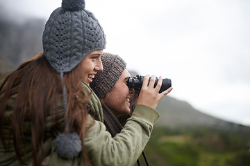 Image showing Couple, travel and binoculars on mountains for journey, adventure and hiking or explore together in winter. Happy man and woman trekking with outdoor search, vision or birdwatching lens in nature