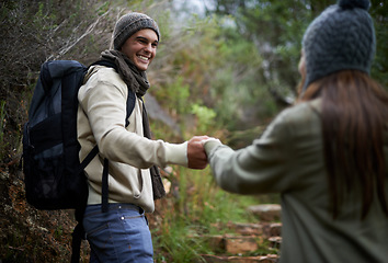 Image showing Happy couple, hiking in nature and holding hands for outdoor adventure, travel and journey in forest or eco woods. Young man woman with love, support and walking or trekking in backpack for winter