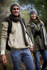 Image showing Couple, portrait and hiking in forest with holding hands for travel, adventure or wellness and fitness. Man, woman and trekking outdoor in woods for cardio, exercise or workout with happy or backpack