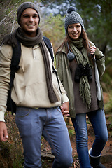 Image showing Couple, portrait and hiking in forest with holding hands for travel, adventure or wellness and fitness. Man, woman and trekking outdoor in woods for cardio, exercise or workout with happy or backpack