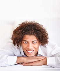 Image showing Man, portrait and happy relaxing in bed on weekend, comfortable and lazy or resting in apartment. Male person, face and smiling in bedroom and calm or peace on holiday or vacation in Amsterdam