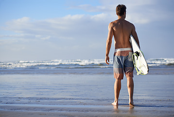 Image showing Surfing, fitness and back of man at a beach with surfboard for freedom, travel or sports outdoor. Ocean, training and male surfer at the sea for swimming, wellness or adventure, workout or holiday