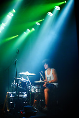 Image showing Music festival, drums and man with instrument by stage and playing in color spotlight at night. Young person, creative drummer and talented musician in band for disco sound and performance at event