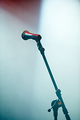 Image showing Microphone stand, empty room and stage for karaoke in spotlight for audio performance with singing. Concert, technology and voice sound with electronics equipment and broadcast for jazz entertainment