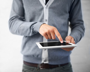 Image showing Person, hands and tablet for research, UI or UX in social media, communication or networking on a gray studio background. Closeup of creative employee touching technology for startup on mockup space