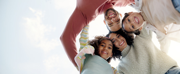 Image showing Face, happy family and bottom hug outdoor for care, love or bonding on vacation, holiday and low angle. Smile, portrait of parents and children embrace together, having fun or enjoying quality time