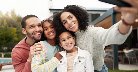 Image showing Children, family and selfie outdoor with a smile, love and care in home backyard. Young latino woman and man or parents hug happy girl kids for a profile picture or social media post on holiday