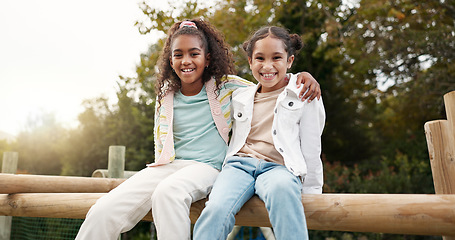 Image showing Friends, happy and children hug in park on jungle gym for bonding, childhood and having fun on playground. Friendship, outdoors and portrait of young girls embrace for playing, freedom and adventure