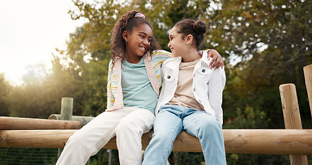 Image showing Friends, happy and children hug in park on jungle gym for bonding, childhood and having fun on playground. Friendship, outdoors and portrait of young girls embrace for playing, freedom and adventure