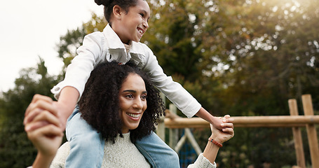 Image showing Mother, daughter and piggyback walking in park or garden for fun bonding, holiday or weekend outside. Happy mom carrying her child on shoulders for family time together in nature or forest by house