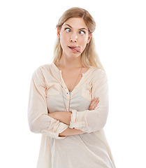 Image showing Funny face, tongue and squint with woman arms crossed in studio isolated on white background for humor. Emoji, comedy or joke and confident young comic feeling silly or goofy with weird body language