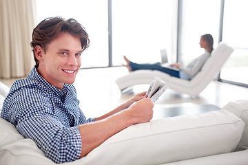 Image showing Man, newspaper and portrait on sofa with relax for story, article or information with smile in living room. Person, news or morning routine on couch with print media or knowledge for break in lounge