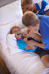 Image showing Happy, laughing and children tickling on bed for love, bonding or family siblings time at home. Smile, excited and young boy kids playing, having fun and relaxing together in bedroom of modern house.