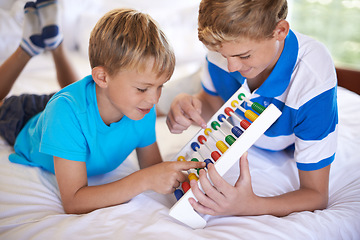 Image showing Children, home and playing with abacus for learning, happy and bonding together with educational for math. Brother, teaching and counting game on bed with sibling love, care and development in house