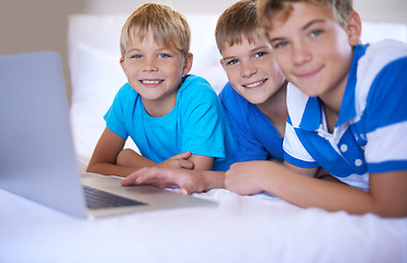 Image showing Brothers, home and portrait on laptop in bedroom, above and excited for online games in house. Young children, happy face and streaming cartoons on bed for bonding together, love and relax on weekend