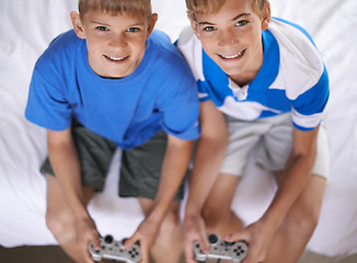 Image showing Brothers, happy and portrait of video game in home, above and excited for online gaming in bedroom. Young children, smile and face for streaming sports on bed, bonding and relax together on weekend