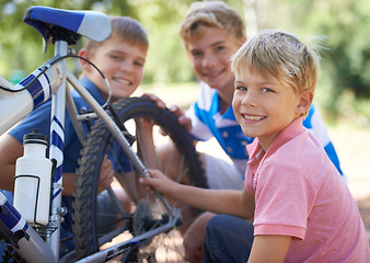 Image showing Children, bicycle and portrait for fixing in park, repairs and excited for fun outdoor on vacation. Young brothers, face or bike maintenance in skill development, care or bonding in summer on holiday