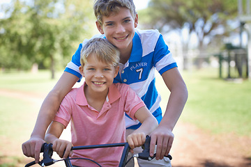 Image showing Nature, smile and portrait of children on bicycle riding in outdoor field, park or forest for exercise. Happy, cycling and confident young boy kids on bike for cardio, hobby or training in a garden.