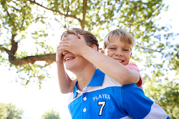 Image showing Children, brother and piggyback in backyard playing or sunshine with cover eyes, game or laughing. Kids, siblings and together in nature for summer bonding activity for happiness, youth or friends