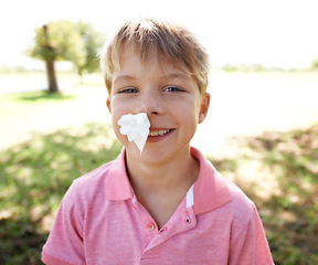 Image showing Child, portrait and nose bleed or paper for outdoor adventure or accident, injury or smile. Kid, boy and happy face with tissue for blood on forest playground for physical activity, sports or nature