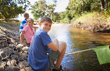 Image showing Children, group and portrait or fishing at river for summer holiday at countryside for vacation, learning or travel. Kids, boys and happy with net for catch adventure at lake for bond, sun or relax