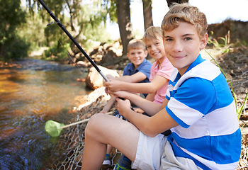 Image showing Children, portrait and fishing rod at river in nature for holiday fun at countryside for vacation, learning or travel. Kids, boys and net for catch adventure at lake for teamwork, teaching or relax