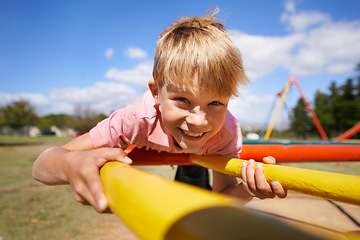 Image showing Portrait, boy and playground with smile, fun and happiness with weekend break and summer. Face, child and kid outdoor, joyful and cheerful with vacation and peaceful with roundabout, fun and excited
