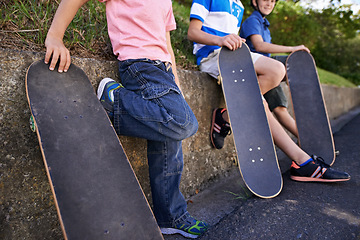 Image showing Kids, friends and skateboard for outdoor sports together or exercise sneakers for workout, balance or city street. People, legs and neighbourhood fitness on road for transport, practice or relaxing