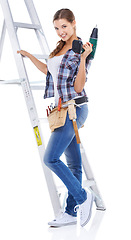 Image showing Woman, portrait and ladder or drill in studio as construction worker for home maintenance, building or white background. Female person, face and tool belt for renovation, contractor or mockup space