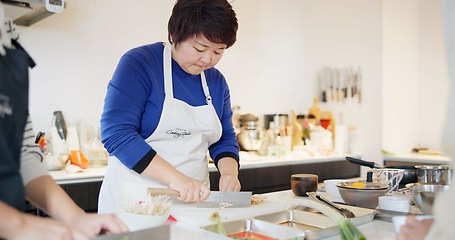 Image showing Japanese chef, woman and kitchen with knife, cooking and prepare ingredients for catering services. Person, food and chopping board for nutrition, diet or health with job in restaurant, cafe or diner