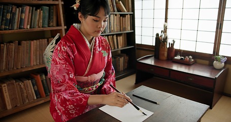 Image showing Ink, writing and Japanese woman in home for traditional script on paper, documents and page. Creative, Asian culture and person with vintage paintbrush tools for calligraphy, font and text in house