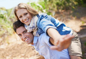 Image showing Couple, portrait and piggyback in nature with freedom in relationship for holiday, vacation or travel. Romance, man and woman or happy outdoor in forest with hug for bonding, love and relax in woods