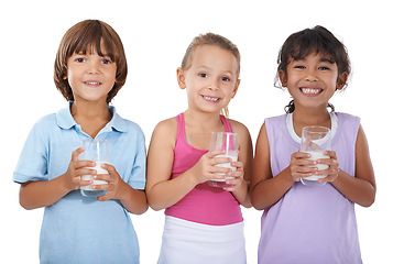 Image showing Milk, glasses and happy portrait of children with nutrition, health and wellness in white background of studio. Calcium, drink and kids smile with dairy, protein and benefits in diet for growth