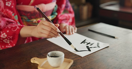 Image showing Ink, Japanese writing and hands of woman in home for traditional script, paper and documents. Creative, Asian culture and person with vintage paintbrush tools for calligraphy, font and text in house