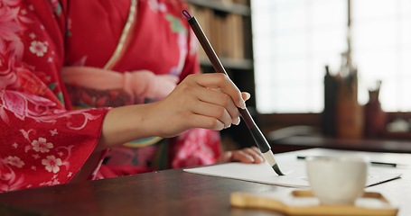 Image showing Ink, calligraphy and hands of Japanese woman in home for traditional script, paper and documents. Creative, Asian culture and person with vintage paintbrush tools for writing, font and text in house