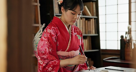 Image showing Calligraphy, writing and traditional Japanese woman in home for script, paper and documents. Creative, Asian culture and person with vintage paintbrush, ink and tools for art, font and text in house