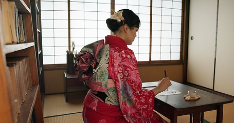 Image showing Traditional, writing and Japanese woman in home for script on paper, documents or page on desk. Creative, Asian culture and person with vintage paintbrush, ink and tools for calligraphy, font or text