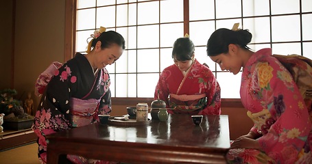 Image showing Japanese, women and bow for tea ceremony in Chashitsu room with kimono dress or custom tradition. People, temae and vintage style outfit or matcha for culture, fashion and happy with antique crockery