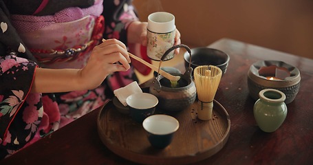 Image showing Traditional, matcha and Japanese woman with tea in home with herbs, powder and flavor in teapot. Ritual, indigenous culture and hand of person with herbal beverage for drinking, ceremony and wellness