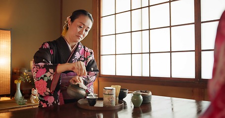 Image showing Traditional, culture and Japanese woman with tea in home with herbs, leaves and flavor in teapot. Kimono, indigenous and person with matcha beverage for ceremony, ritual and wellness for drinking