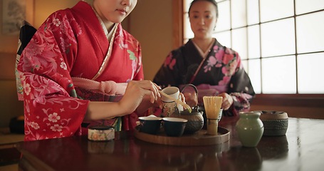 Image showing Traditional, teapot and Japanese women with tea for culture with herbs, leaves and flavor in home. Ritual, indigenous and people with herbal beverage for calm, ceremony and drinking for wellness