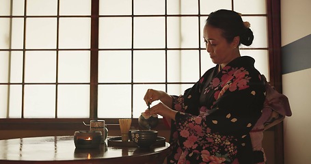 Image showing Tea, Japanese woman and traditional with a teapot, flavor and drinking ritual with herbal beverage and leaves. Asian person with culture and ceremony with Kimono, home and calming with wellness