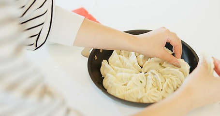 Image showing Japan, hands and dumplings on table for dinner, brunch and traditional meal in restaurant or cafe. Culture, gyozo and asian cuisine for nutrition, healthy diet and lunch with preparation or pastry