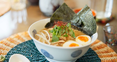 Image showing Ramen, food and restaurant bowl in Tokyo with traditional soup, meal and Japanese course on table. Egg, dinner and Asian cuisine in a cafeteria with a plate serving with noodles, tofu and seaweed