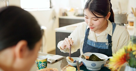 Image showing Japanese woman, eating and lunch in restaurant, chopsticks and hungry with plate for nutrition. Girl, people and food for health, wellness and diet with choice at cafeteria, diner and brunch in Tokyo