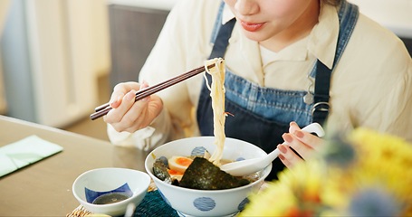Image showing Japanese woman, eating ramen and restaurant with chopsticks, hungry and lunch for nutrition. Girl, person and meal for health, wellness and diet with noodles at cafeteria, diner and brunch in Tokyo